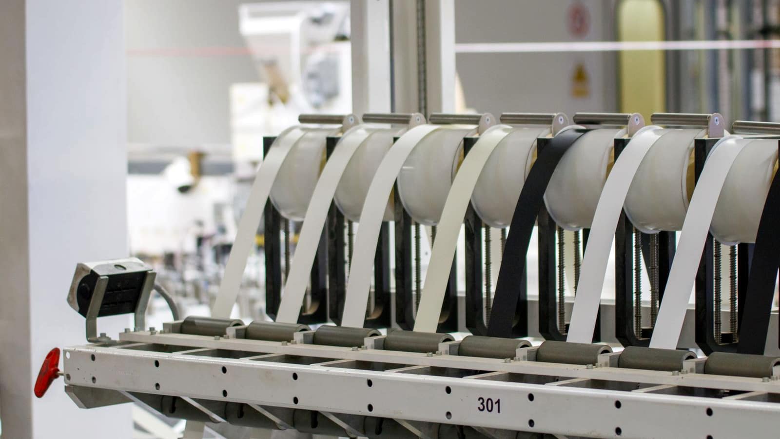A row of machinery on a line inside a modern manufacturing facility