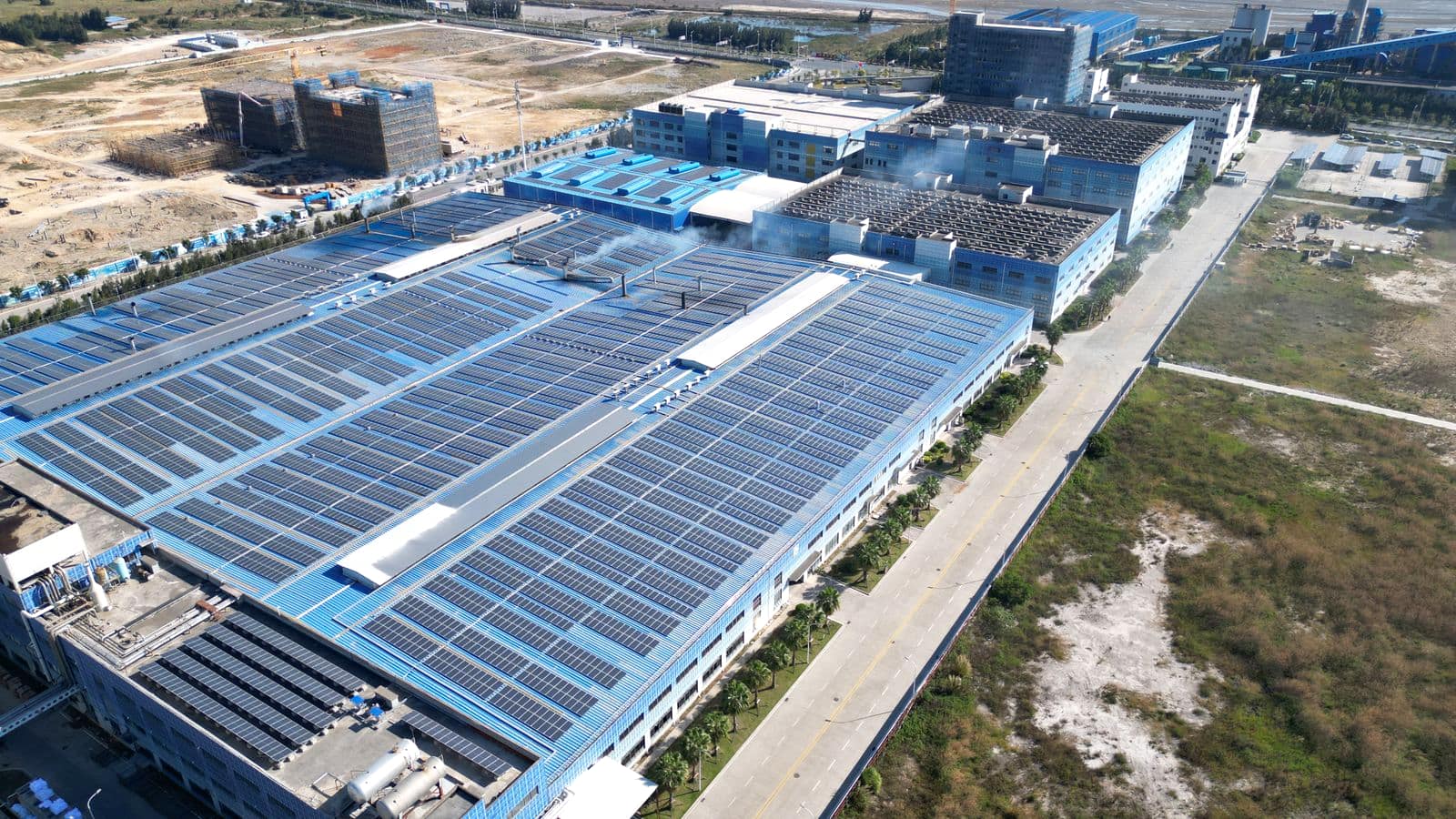 Aerial view of solar panels covering the roof of a large industrial building