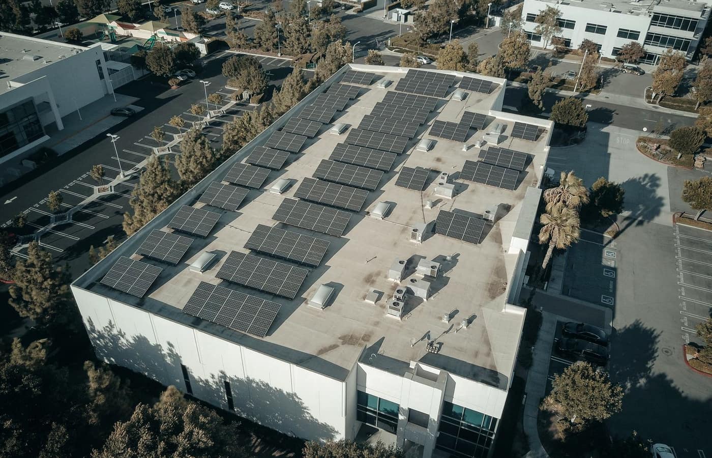 Aerial view of a solar array on the flat roof of a commercial building
